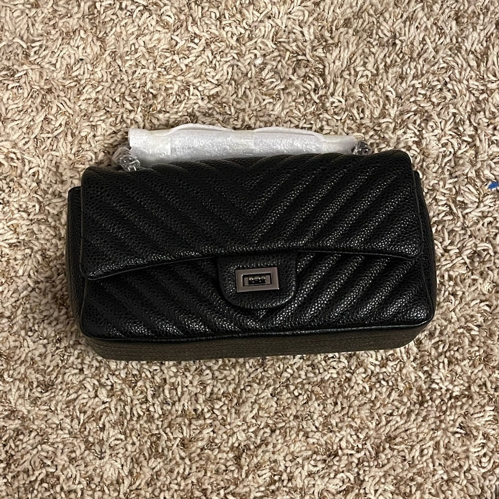 Black faux leather crossbody with metal colored straps